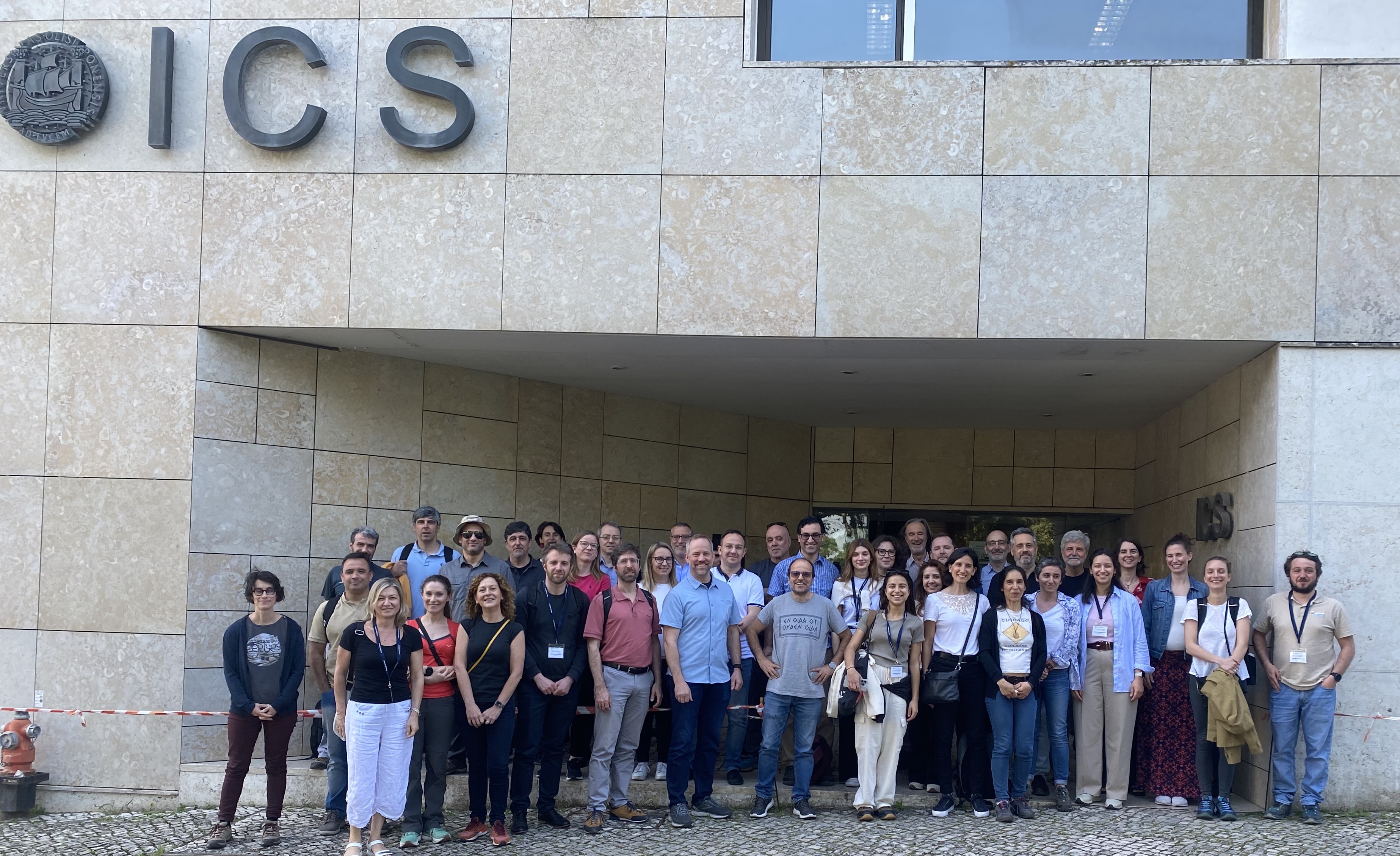 Group photo of partners outside ICS building